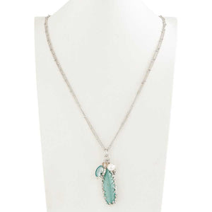 Antique silver double chain with a 2.5" long turquoise pendant accompanied by an aquamarine, pearl and crystal charms.  Chain measures 30" long with a 2.5" extender.