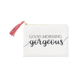 White zippered cosmetic bag with the words "Good Morning Gorgeous" painted on and a lovely pink tassel hanging off of the zipper. 