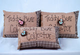 small quilted look decorative pillow with the words "Teddy Bear Collector" stitched on front as well as an adorable teddy bear button 